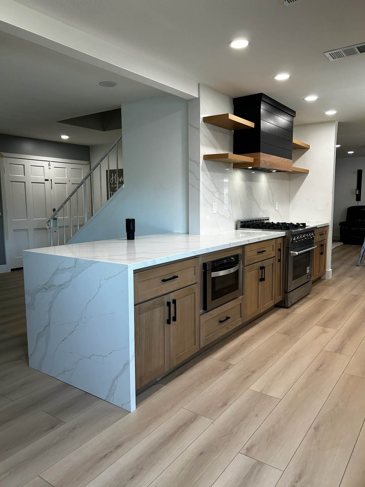 Modern kitchen with wooden floor and white marble island